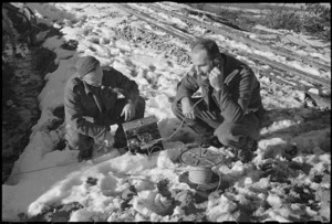 Signallers A McKechie and R J McConway testing ground lines after a snow-storm on the Italian Front, World War II - Photograph taken by George Kaye