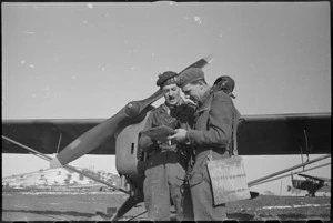 British Captain Aitchison and Flight Commander Captain Henderson discuss flying task for NZ Artillery on the Italian Front, World War II - Photograph taken by George Kaye