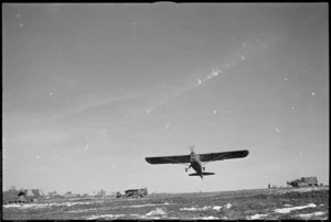 Light RAF reconnaissance aircraft takes off in the NZ Artillery area on the Italian Front, World War II - Photograph taken by George Kaye
