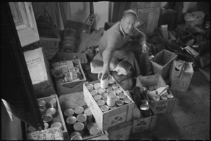 'Snow' Burton sorting out rations on the Italian Front, during World War II - Photograph taken by George Kaye