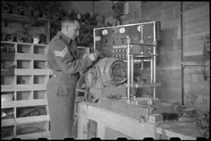 Sergeant Priest working with automotive electrical equipment testing set, Maadi Camp, Egypt - Photograph taken by George Bull