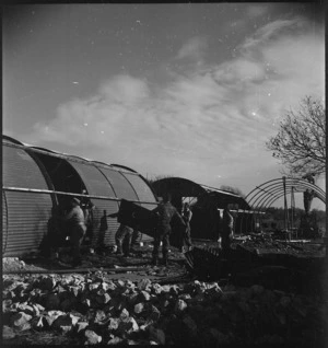 Nissen huts being erected at the New Zealand Advance Base Camp in Italy, World War II - Photograph taken by M D Elias