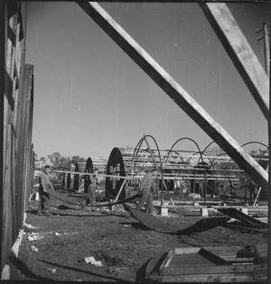 Nissen huts being erected for offices and messes at the New Zealand Advance Base Camp in Italy, World War II - Photograph taken by M D Elias