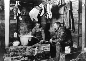 Cecil H Meares and Dimitri Geroff by the blubber stove in the Discovery hut, Antarctica