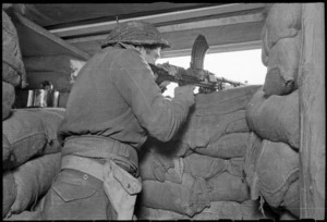 New Zealand soldier firing a machine gun, Faenza, Italy, during World War 2