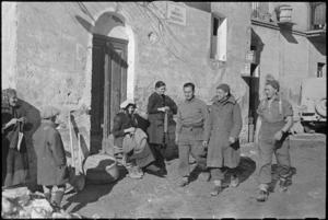 NZ soldiers strolling through village where they are billetted behind the Italian front line, World War II - Photograph taken by George Kaye