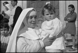 Roman Catholic nun with orphan child from orphanage in Castelfrentano, Italy, World War II - Photograph taken by George Kaye