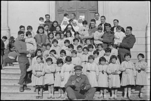 Orphan children in front line village make friends with New Zealanders, Castelfrentano, Italy, World War II - Photograph taken by George Kaye