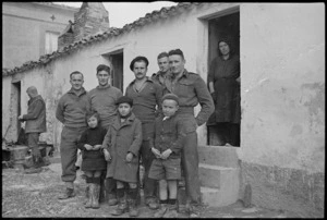 New Zealanders outside their temporary home in a village just behind the Italian front line, World War II - Photograph taken by George Kaye