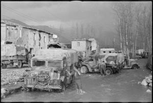 Drivers of New Zealand Division vehicles washing their trucks in Alife, Italy, during World War II - Photograph taken by George Kaye