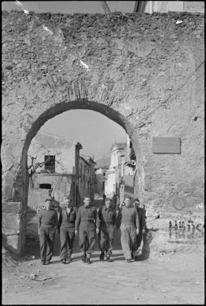 New Zealand soldiers pass under archway leading from Italian town of Alife in World War II - Photograph taken by George Kaye
