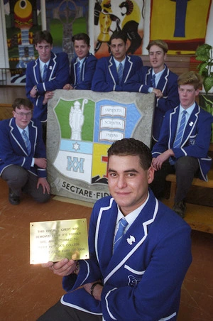 Boys from St Patrick's College, Wellington, with the school crest they retrieved from the College's former site - Photograph taken by Melanie Burford