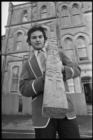 Student from St Patrick's College, Wellington, Todd Wano, with the Maori post he carved for the new school buildings in Rongotai - Photograph taken by John Nicholson