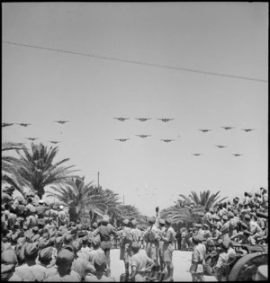 Planes in formation fly past during parade of Allied forces in Tunis, World War II - Photograph taken by M D Elias