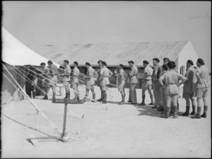 New Zealand soldiers lined up outside a Field Ambulance Unit to donate blood, Maadi - Photograph taken by G Bull