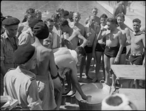 Lemonade refreshments from a tub at 19 NZ Armoured Regiment swimming sports, Cairo - Photograph taken by G Kaye