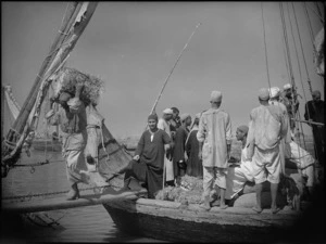 Buyers carrying goods off boat on Nile, Egypt - Photograph taken by George Kaye