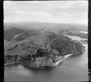 The Snow Rainger property on a headland with buildings, bush and steep cliffs north of Hatfield's Beach settlement, North Auckland, with the Hibiscus Coastal Highway and the Waiwera Hill Scenic Reserve