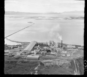 Portland Cement Works looking east with railway and jetty with ships, with inner Whangarei Harbour beyond, Northland