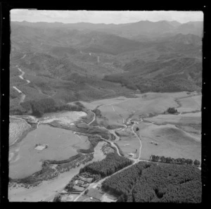 View of rural buildings, farmland, a small lake and river surrounded by forestry, Whangamata, Thames-Coromandel District