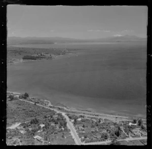 Lake Taupo shoreline with Lake Terrace and Mere Road with residential housing, with Tapuaeharuru Bay and Mount Ruapehu beyond