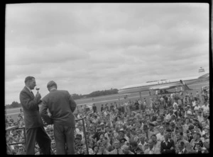 Mr Cunningham addressing crowd with BOAC Comet on runway behind, Whenuapai, Auckland Region