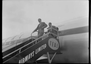 Mr Cunningham and unidentified man on gangway of TEAL DC6, Whenuapai, Auckland Region