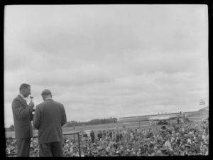 Mr Cunningham addressing crowd with BOAC (British Overseas Airways Corporation) Comet on runway behind, Whenuapai, Auckland Region