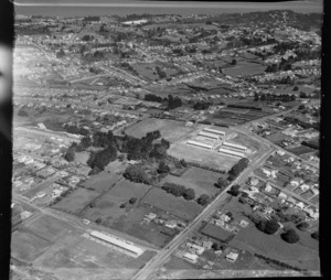 Kelston Primary School and Kelston Girls' College with Archibald Road in foreground, with the Manukau Harbour beyond, Auckland City
