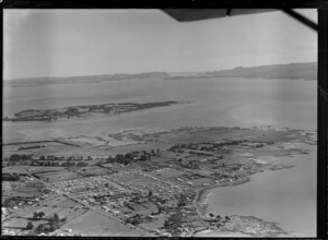 Mangere housing area with Wallace Street and Kiwi Esplanade in foreground, with Puketutu Island and the Manukau Harbour beyond, Auckland City