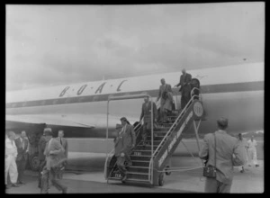 Unidentified passengers on gangway of TEAL Comet aircraft with people watching, Whenuapai, Auckland Region