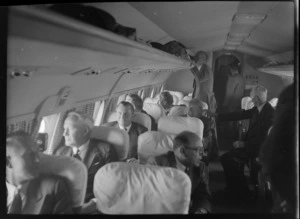 Mr D M Rae MP on left and Mr D Rae MP on right, inside TEAL Comet aircraft with unidentified men, Whenuapai, Auckland Region