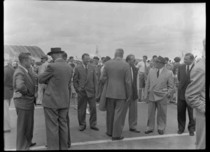 Unidentified men on runway waiting for flight of TEAL Comet aircraft, Whenuapai, Auckland