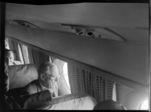 Mr H J Luxford, Mayor of Auckland, inside TEAL Comet aircraft with unidentified men, Whenuapai, Auckland