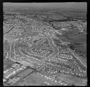 Mt Roskill residential housing subdivisions with the Wesley Intermediate School and Stoddard Road, and the Manukau Harbour beyond, Auckland City