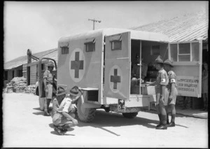 Men of NZ Field Ambulance Unit examine ambulance donated by Miss E W Bellamy, Maadi - Photograph taken by G Bull