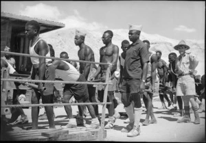 Belgian Congo troops work with NZ engineers to rebuild pontoon bridge across Suez Canal, World War II - Photograph taken by George Kaye
