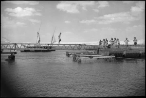 NZ engineers position box girder in the rebuilding of a pontoon bridge across Suez Canal, World War II - Photograph taken by George Kaye