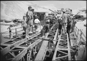 NZ engineers aided by Belgian Congo troops rebuild pontoon bridge across Suez Canal, World War II - Photograph taken by George Kaye