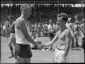 Runner up Johns congratulates McCalman winner of the three mile race at NZ Division Athletics Championships, Cairo, Egypt, World War II - Photograph taken by George Kaye