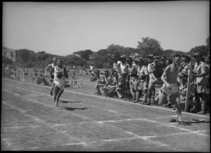 W P McHugh finishes ahead of C Masters to win the 220 yards race at NZ Division Athletics Championships, Cairo, Egypt, World War II - Photograph taken by George Kaye
