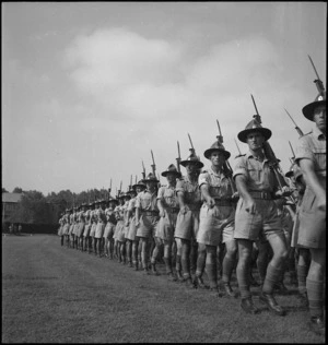 Members of 6th NZ Infantry Brigade march past at Maadi Sports Ground, Egypt - Photograph taken by G F Kaye