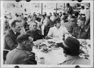 Mrs Theron and Mr Terence Shone help to entertain repatriated POWs during a garden party at Gazira Sporting Club, Cairo