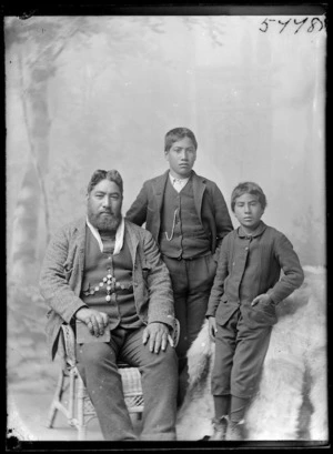 Group portrait of a Maori man and two children