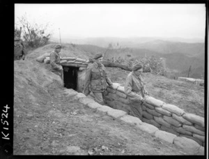 Minister of Defence, Thomas Lachlan MacDonald, and the Government member for Tamaki, Eric Henry Halstead, leaving a front line position by a communication trench, Korea