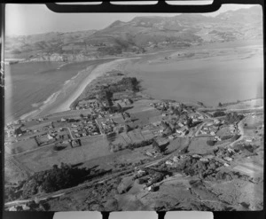 Warrington coastal settlement with Coast Road and railway line in foreground, Warrington Beach and Recreational Reserve spit with Blueskin Bay beyond, Otago Region