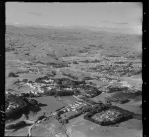 Raiha Street in foreground with Porirua Hospital and School, with the Johnsonville-Porirua Motorway and railway in the valley below, looking to Porirua East beyond, Wellington Region