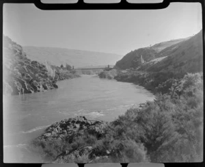 The Clutha River with steel suspension bridge, hills beyond, Roxburgh, Otago Region