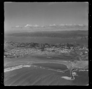 The Wellington City eastern suburbs of Rongotai with Lyall Bay and Wellington Airport under construction in foreground to Strathmore, Miramar and Wellington Harbour beyond