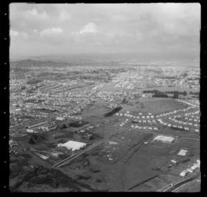 Stoddard Road with bus depot and lumberyard, Winstone Park and Mount Roskill Grammar College, with Onehunga beyond, Auckland